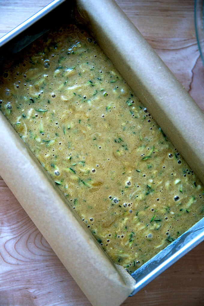 A loaf pan filled with zucchini bread batter.