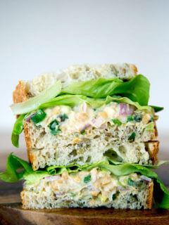 No-tuna "tuna" salad sandwich, cut and stacked on top of one another.