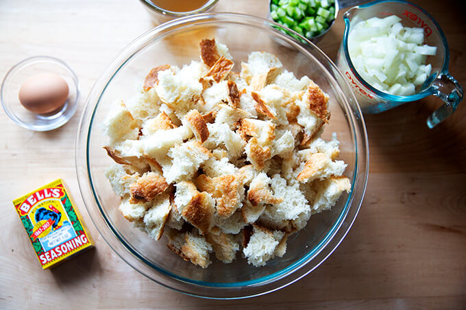A bowl of cubed bread and ingredients to make a classic bread stuffing. 